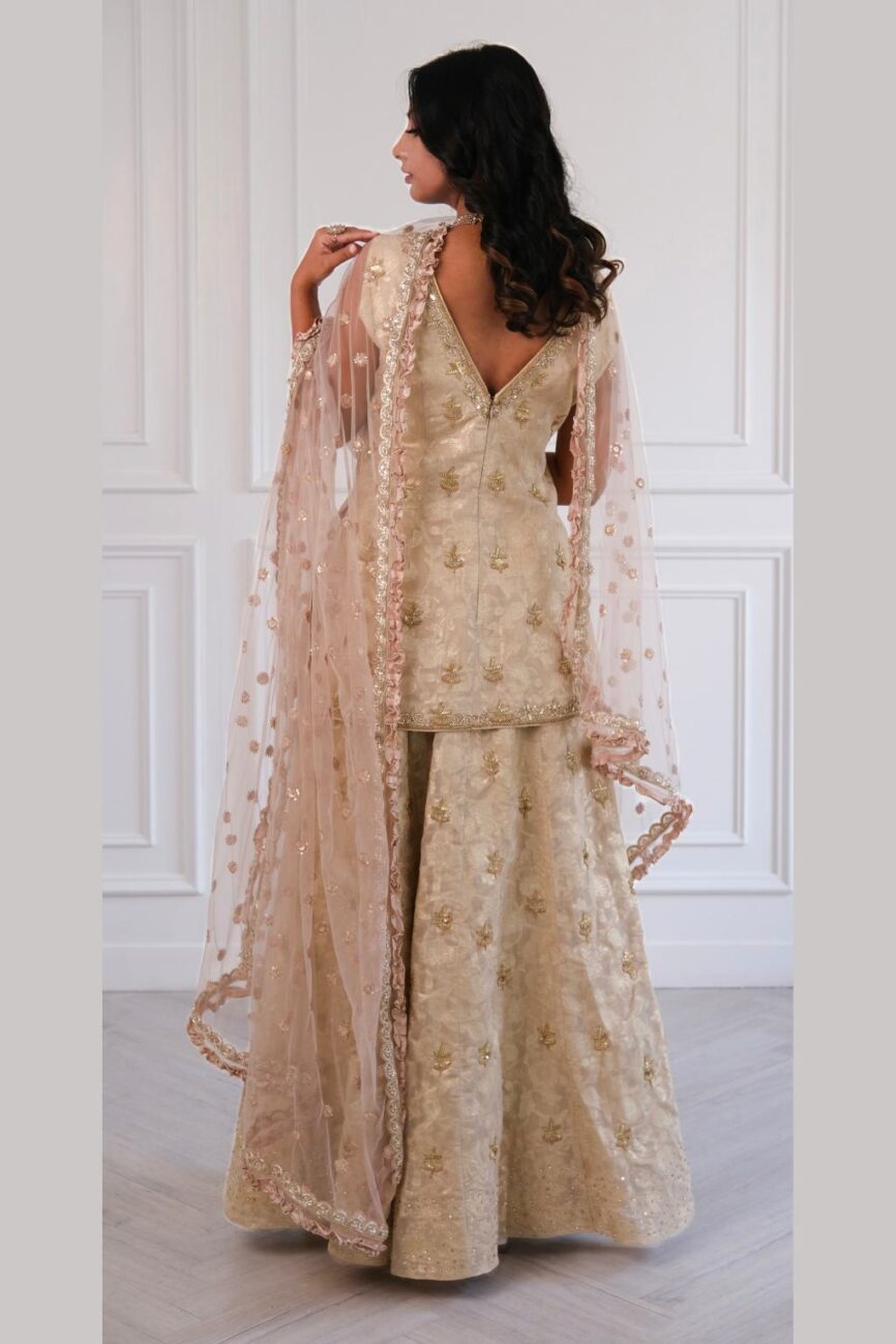 Model wearing Ivory Banarasi hand-embroidered lehenga kurta set – SARA by Rashi bridal collection.