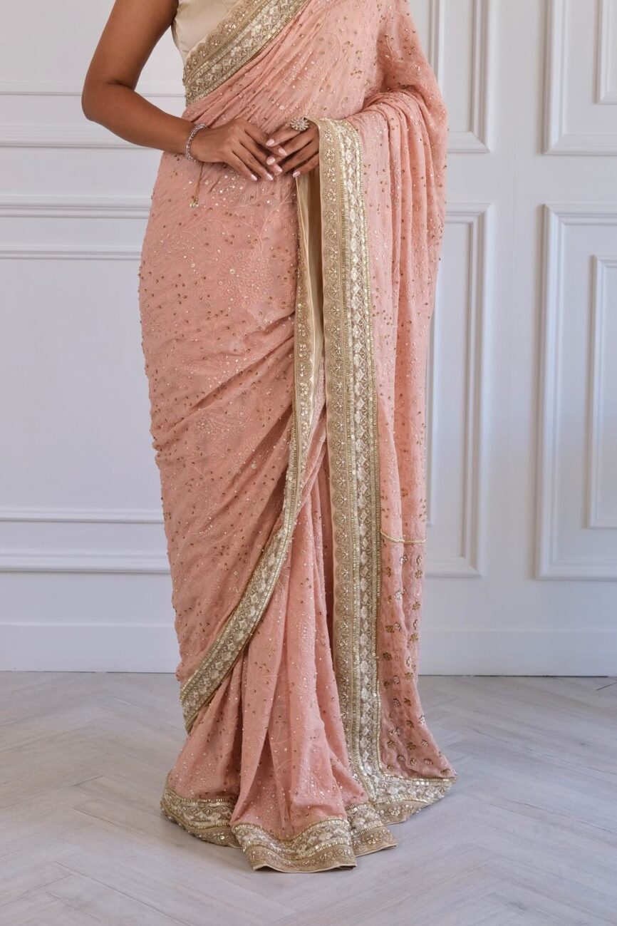Pink and taupe chikankari saree with embroidered border and pallu.