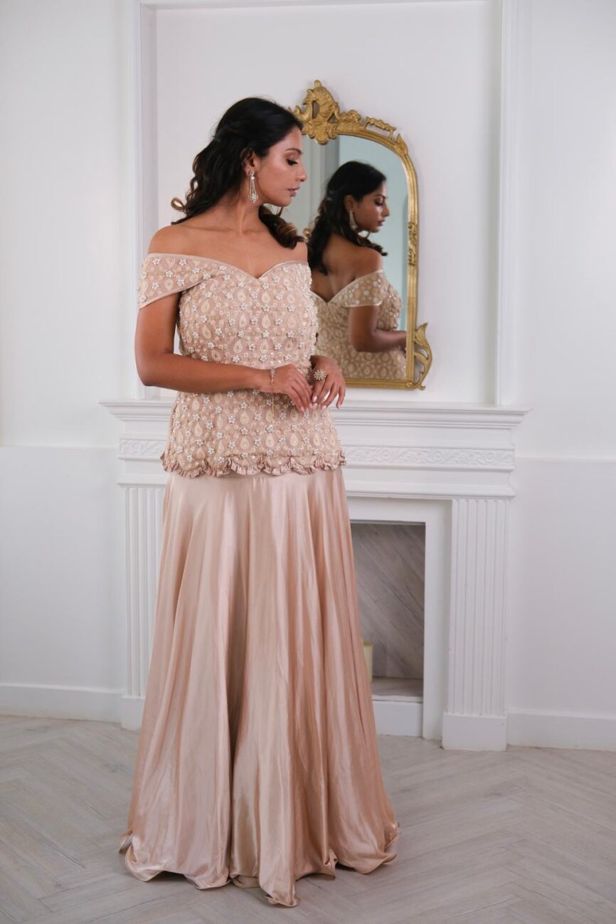Flowing taupe satin skirt highlighting its smooth drape and elegant fall.