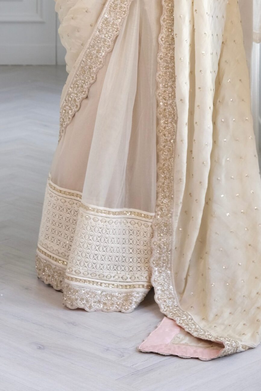 White tissue saree with chikankari embroidered border and pallu design.